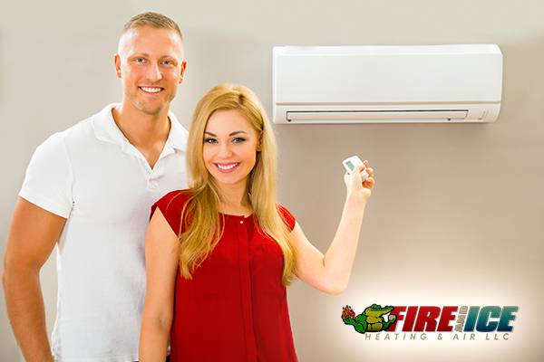AC Installation Service with the couple smile holding a remote control in Gonzales